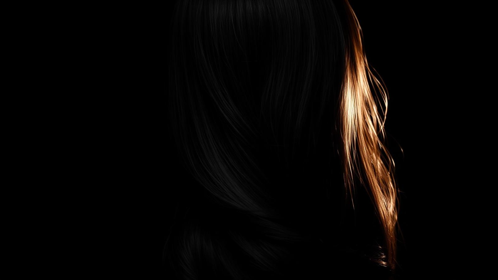 Glossy styled hair under soft studio light