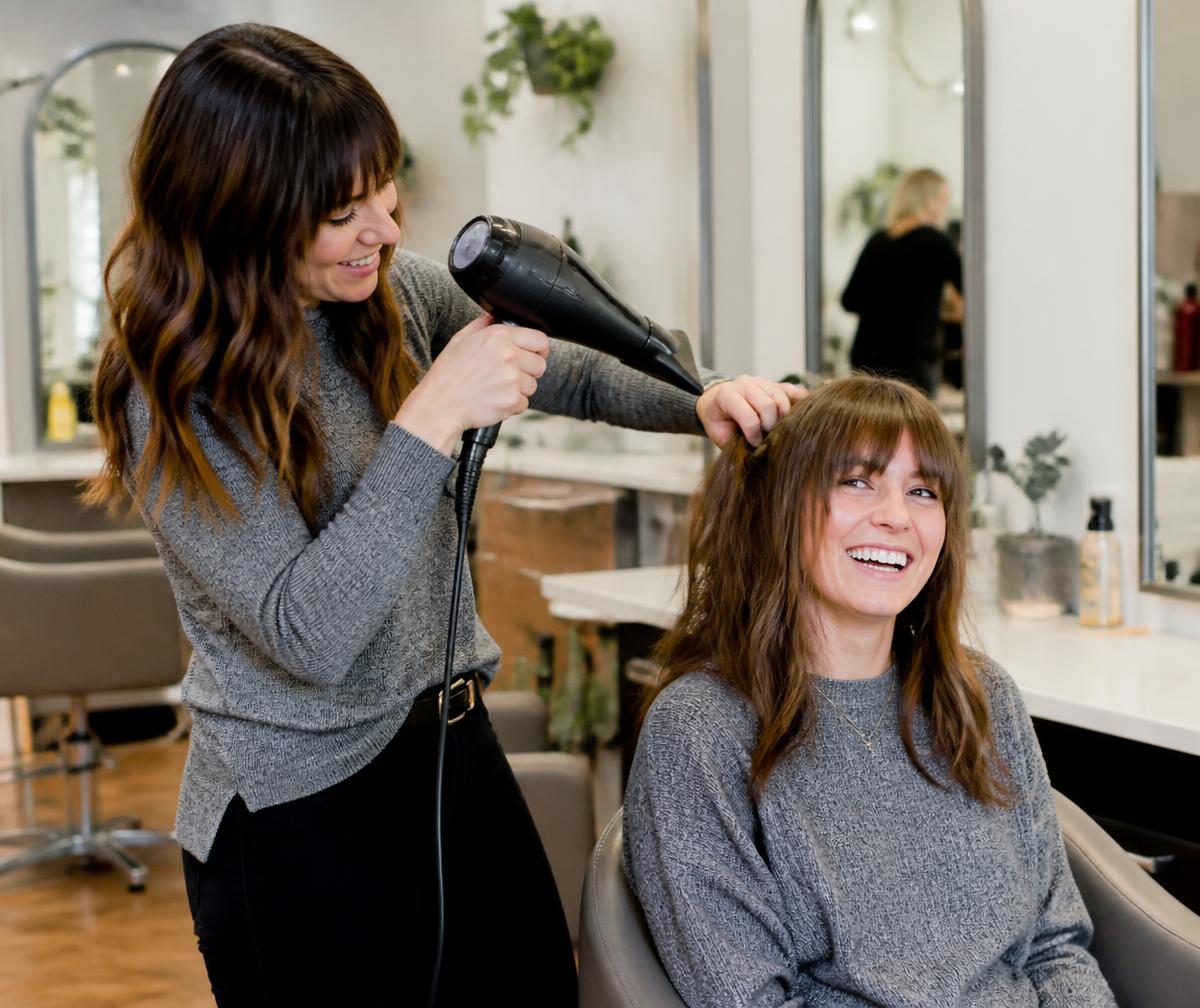 Eve stylist finishing a client's hair